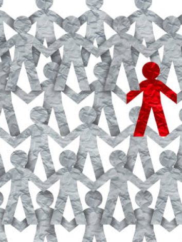 Racism symbol or individuality icon or a contagious and infectios person self isolating or social distancing issue in a crowd.